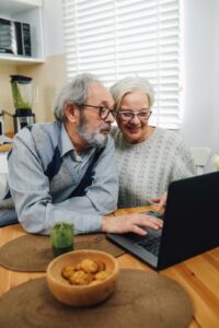 Elderly couple at home using a computer